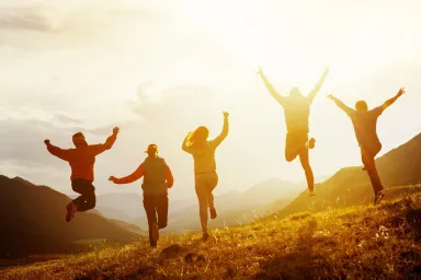 friends laughing together outdoors joy meaning
